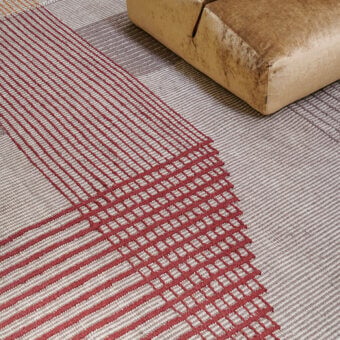 Exceptional Amini RD Trace rug hand-woven in New Zealand wool with intersecting reddish-brown geometric patterns and a clipped finish