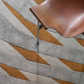 Lavish Amini RD Twist rug with captivating wave patterns in cream sand, basil green, ochre, gray and off-white wool and silk blend