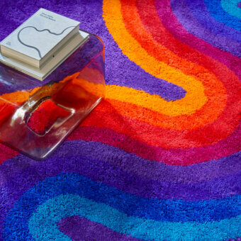 Exceptional Amini Romantica-Curve rug with swirling shades of purple, red, orange, yellow, and blue crafted from New Zealand wool with a hand-washed finish