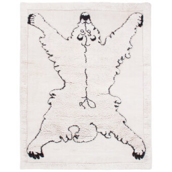 Exceptional Amini Tapiorso rug crafted in India with ivory wool and striking black animal outline design