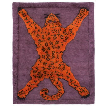 Exceptional Amini Tapipardo rug with vibrant orange and black spotted feline against a rich purple pure wool field and carved pile