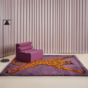 Distinguished Amini Tapipardo rug with cheetah depiction in orange and yellow hues against a textured purple pure wool background crafted with a hand-washed finish