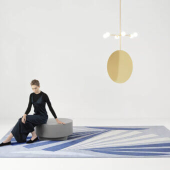 Sophisticated Amini Ventaglio rug showcases a radiating fan design in blue hues with wool and natural silk, finished with meticulous hand washing