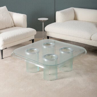 Exceptional Driade Coupelle coffee table crafted in clear glass with a glossy, water-like thermoformed tabletop and cylindrical legs