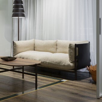 Distinguished Enrico Pellizzoni Iris sofa with dynamic metal support and heavily textured off-white looped-pile textile detailing