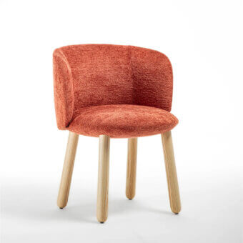 Distinguished Enrico Pellizzoni Isabel chair upholstered in textured terracotta bouclé with beautifully turned natural ash wood legs