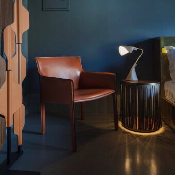 Exceptional Enrico Pellizzoni Pasqualina lounge chair with reddish-brown leather upholstery and satin finish crafted in dark-toned wood