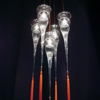 Exclusive melogranoblu Opera - Turandot suspension lamp handcrafted from ruled hand-blown glass with a vibrant orange silk tassel and red cord