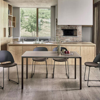 Elegant Bontempi Polo chair with contoured form in dark gray synthetic material and matte metal sled base