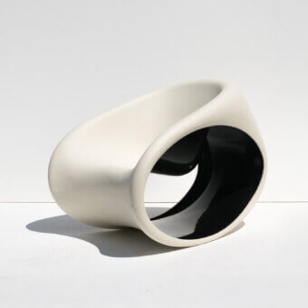 Innovative Driade MT3 rocking lounge chair with matte sand white exterior and glossy deep black interior polyethylene monoblock construction