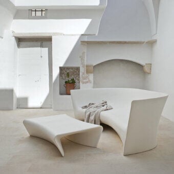 Elegant Driade Piaffè coffee table crafted in off-white polyethylene monoblock with a matte finish and flowing wave-like base
