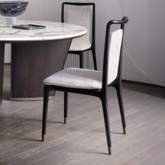 Graceful Giorgetti Ibla chair sculpted from solid ash wood with dark matte finish and light gray textured textile upholstery