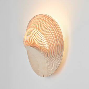 Exceptional Luceplan Illan wall lamp crafted in layered wood with a warm honeyed brown finish emitting a soft upward glow