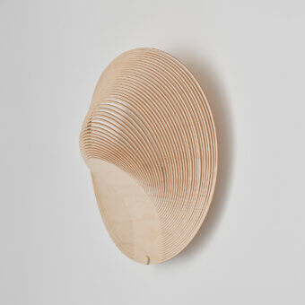 Distinctive Luceplan Illan wall lamp crafted in layered wood with a satin finish and warm upward illumination