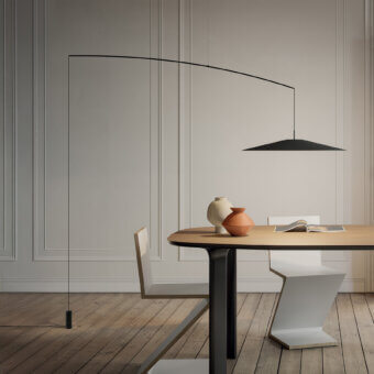 Distinguished Luceplan Koinè floor lamp in aluminum, carbon, and glass with a matte black finish delivers a broad cone of light