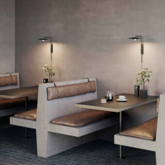 Distinguished Luceplan Koinè wall lamp crafted in aluminum with a refined matte finish and a dark geometric silhouette