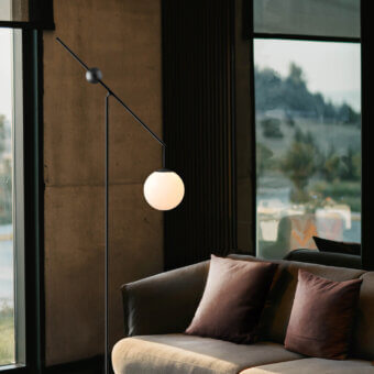 Distinguished Luceplan Malamata floor lamp crafted in matte dark gray metal with a frosted white blown-glass diffuser for balanced illumination