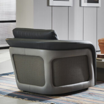 Exceptional Mascheroni Bellini Harry lounge chair with flowing curves and perforated leather shell in dark and lighter gray tones