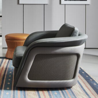 Distinguished Mascheroni Bellini Harry lounge chair with rounded form in muted gray and Vienna straw detailing crafted with perforated leather