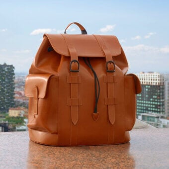 Distinguished Mascheroni Biggie backpack crafted in Italy with glossy medium-toned brown leather and practical interior pockets