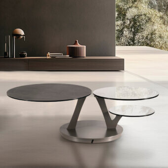 Innovative Naos Bio coffee table with synchronized revolving glass tops and matte dark-toned painted steel base