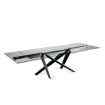 Elegant Naos double extendable dining table with a sleek glass tabletop and painted dark metal sculptural base