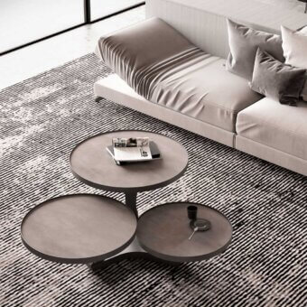 Innovative Naos Extremis coffee table with rotating matte gray ceramic tops and painted steel base
