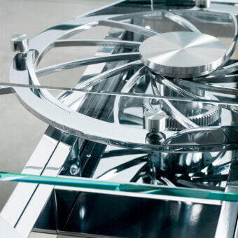 Exceptional Naos Quasar table crafted with stratified glass legs and a polished silver finish glass top