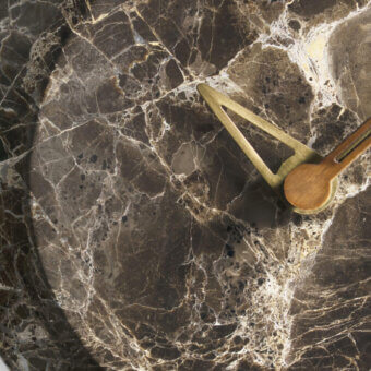 Exceptional Nomon Bari wall clock with a dark marble face, polished brass hands and warm walnut accents
