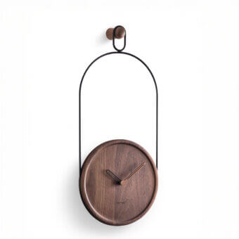 Refined Nomon Eslabón Wall Clock crafted in matte black metal with a natural walnut plate and satin finish