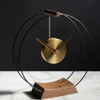 Distinguished Nomon Mini Aire table clock with double black fiberglass, warm walnut, and delicate brass details