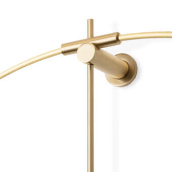 Elegant Nomon New Anda wall clock with a suspended metal ring and warm gold satin finish