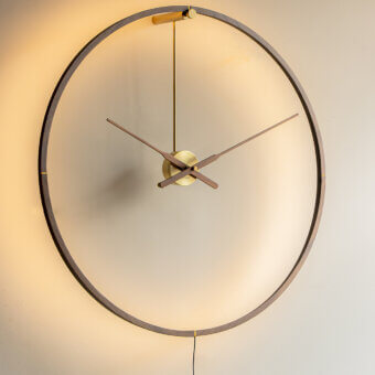 Elegant Nomon Ombra Premium Clock Lamp wall-mounted in dark anodized wood with a golden-toned metal clock face
