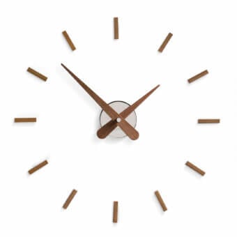Exceptional Nomon Sunset wall clock with a white face and elongated wooden hour markers in a matte wood finish