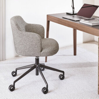 Elegant Porada Abby swiveling armchair with textured gray and white textile upholstery and sleek black metal base with castors