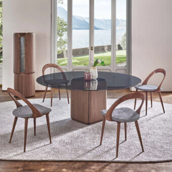 Distinguished Porada Bay round table with a solid Canaletta walnut base and glossy glass top crafted in Italy