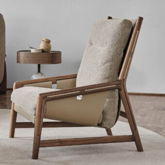 Distinguished Porada Bice armchair with solid Canaletto walnut frame, textured neutral gray textile and Champagne metal detailing