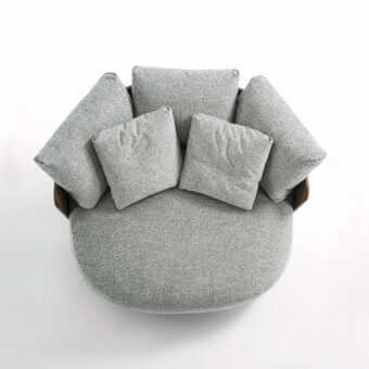 Lavish Porada Calin XL lounge chair built with curved Canaletta walnut and plush light gray textile upholstery with a subtle speckled finish