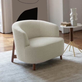 Distinguished Porada Copine armchair with soft bouclé textile upholstery and satin-finish wooden frame