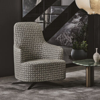 Sophisticated Porada Copine Bergere armchair with muted gray textured textile upholstery and dark metal swiveling base