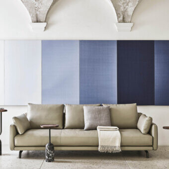Lavish Porada Étienne sofa with pale beige leather upholstery, light grey Microflock cushion and pewter grey metal feet with wooden inserts