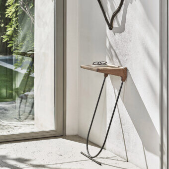 Refined Porada Maori console with a solid canaletta walnut top and pewter grey metal frame in a satin finish