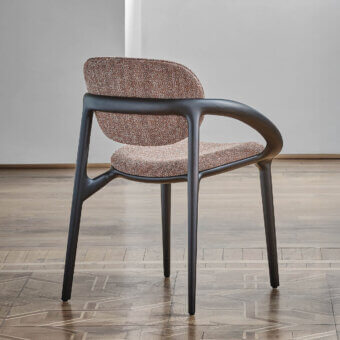 Distinguished Porada Molly armchair with a canaletto walnut frame and textured warm brown beige textile upholstery with a matte finish