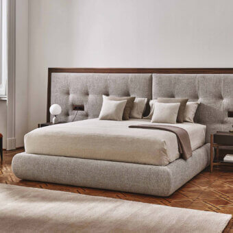 Distinguished Porada Morfeo bed with gently shaped form and textured neutral gray-beige upholstery, crafted in Italy with a dark wood outline