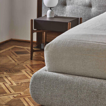 Exceptional Porada Morfeo bed with inviting contours and muted gray textile upholstery, built with a wood frame and satin finish