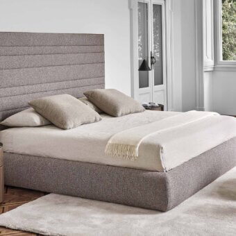Lavish Porada Morfeo bed with gently shaped silhouette and neutral gray textured fabric upholstery crafted in Italy