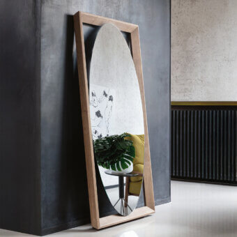 Distinguished Porada Odino mirror with a bold geometric frame and organically curved reflective surface crafted in ash wood with a light to medium tone finish