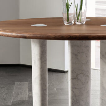 Distinctive Porada Osmose round table crafted with canaletto walnut and subtly veined marble legs with a polished finish