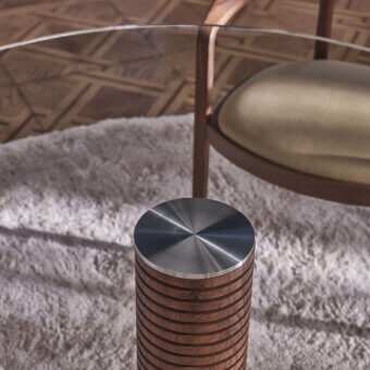 Distinguished Porada Sansiro table with a clear glass top and a central leg crafted from canaletto walnut in Bronzoro finish