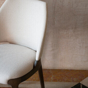 Distinguished Potocco Velis Hug chair upholstered in light beige textured textile with a satin-finish medium-brown wood frame